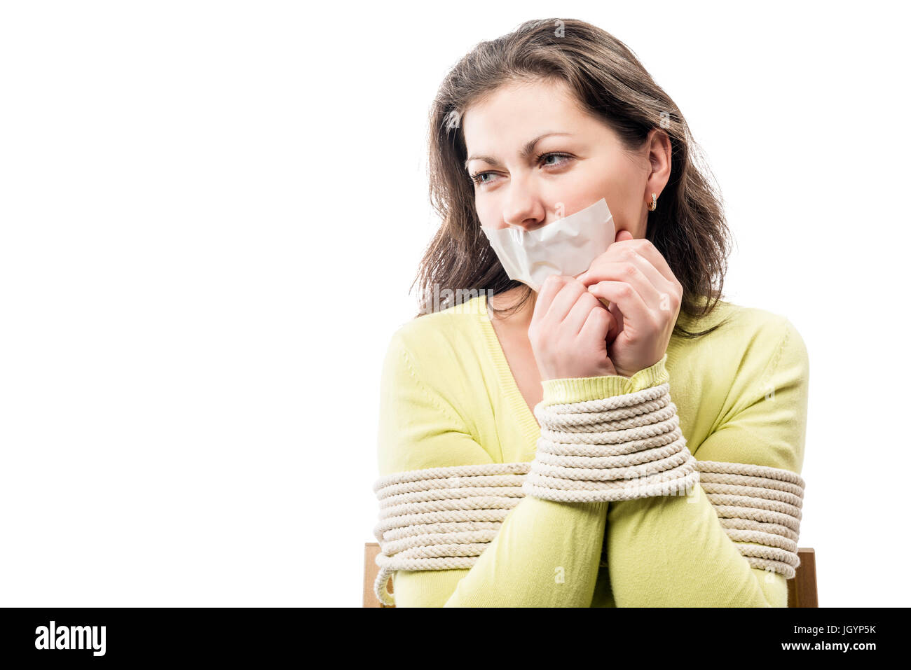 Close-up portrait of a hostage bound with a sealed mouth Stock Photo