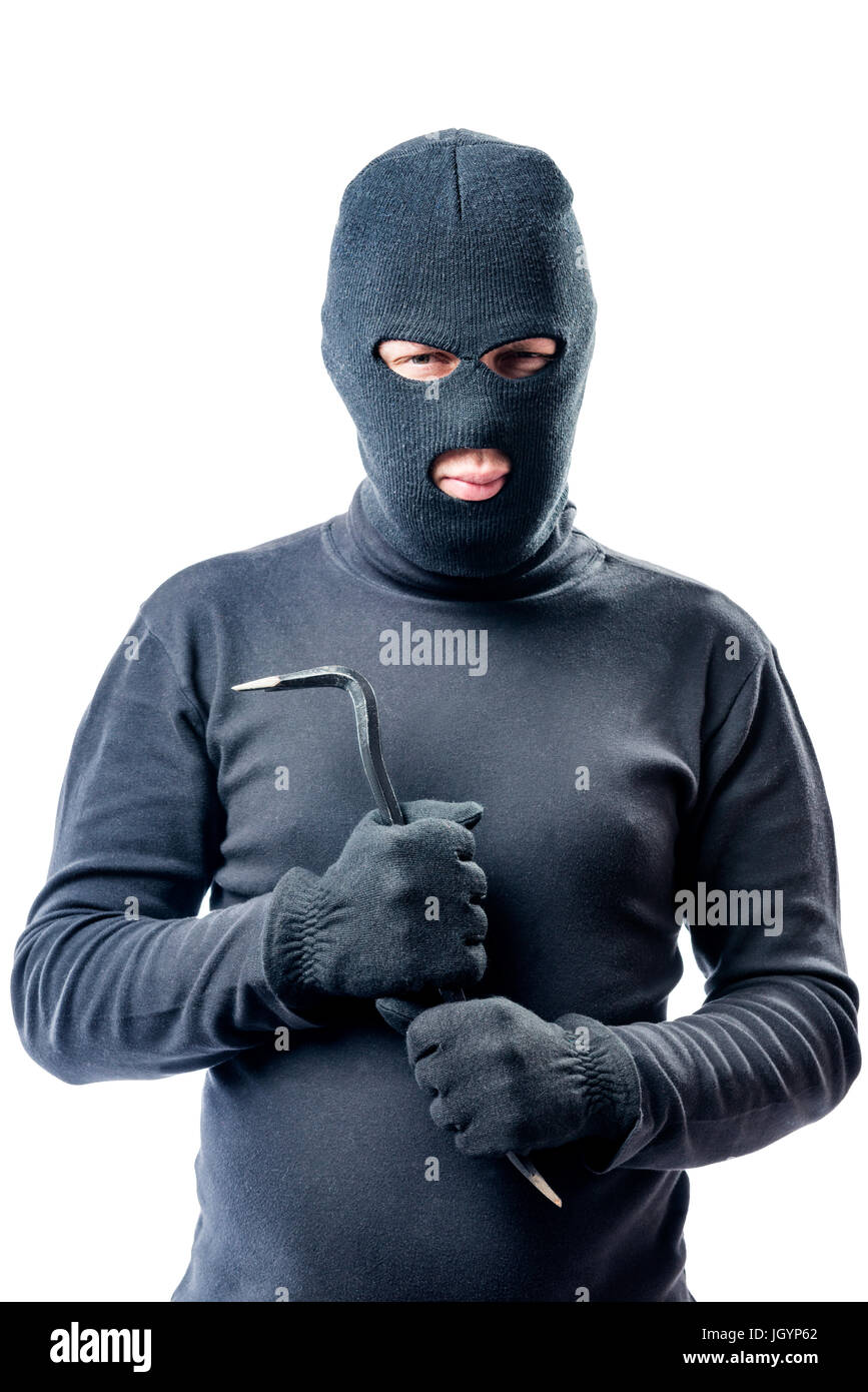 Criminal with a crowbar in hands in a black balaclava posing against a white background Stock Photo