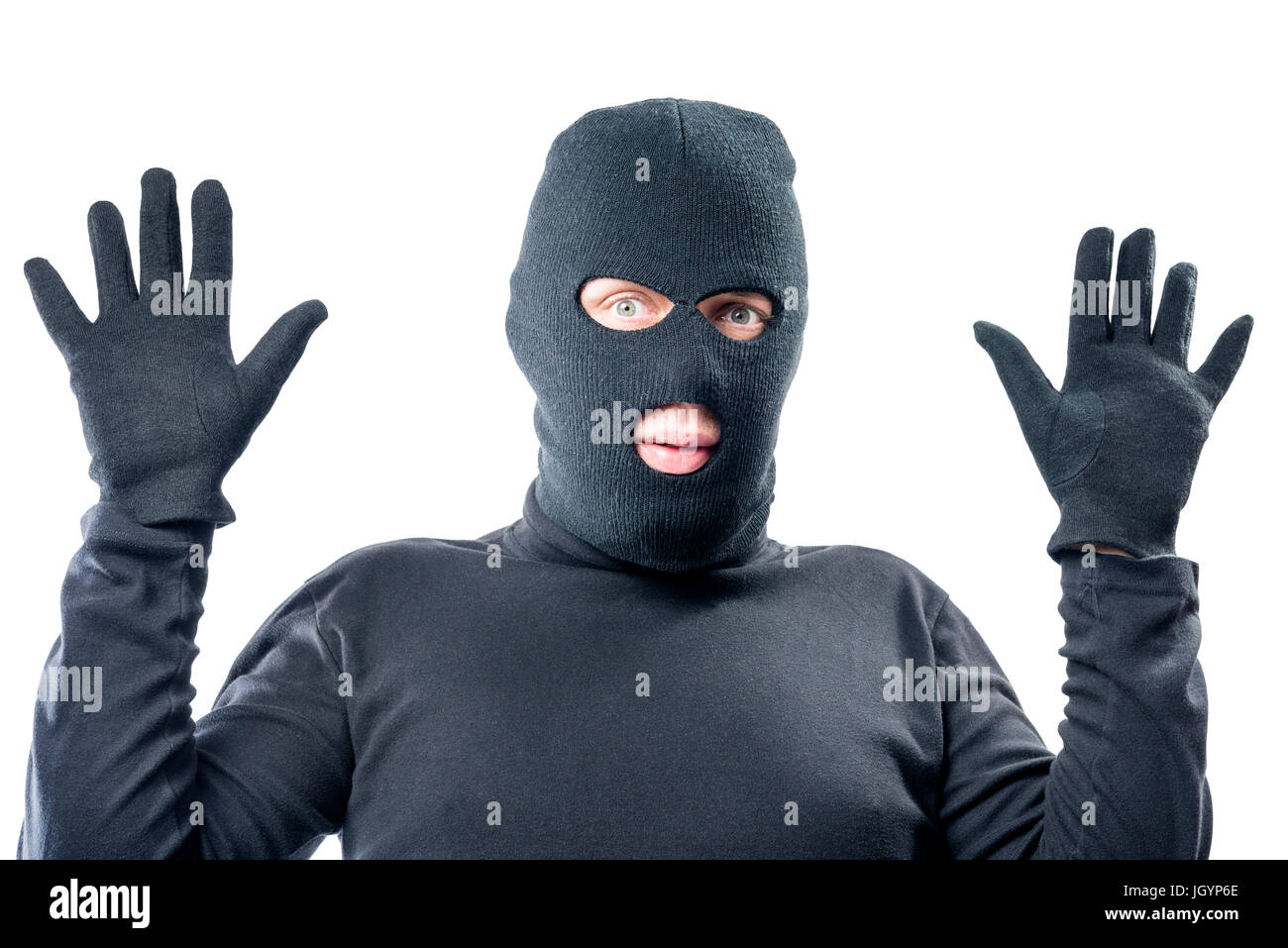 male robber held up his hands, in black clothes Stock Photo