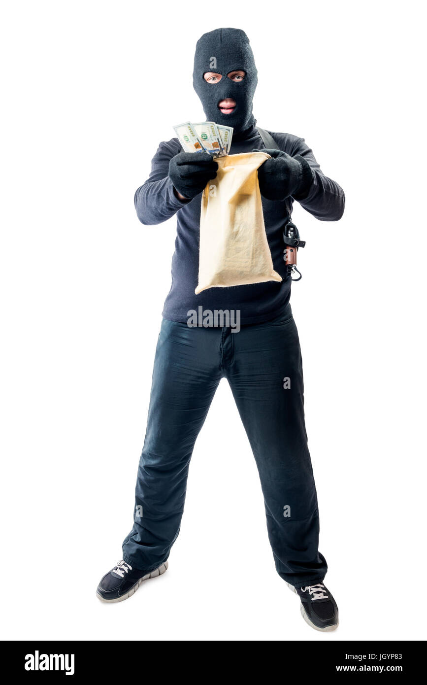 Male robber in full length is holding bag with money on white background Stock Photo