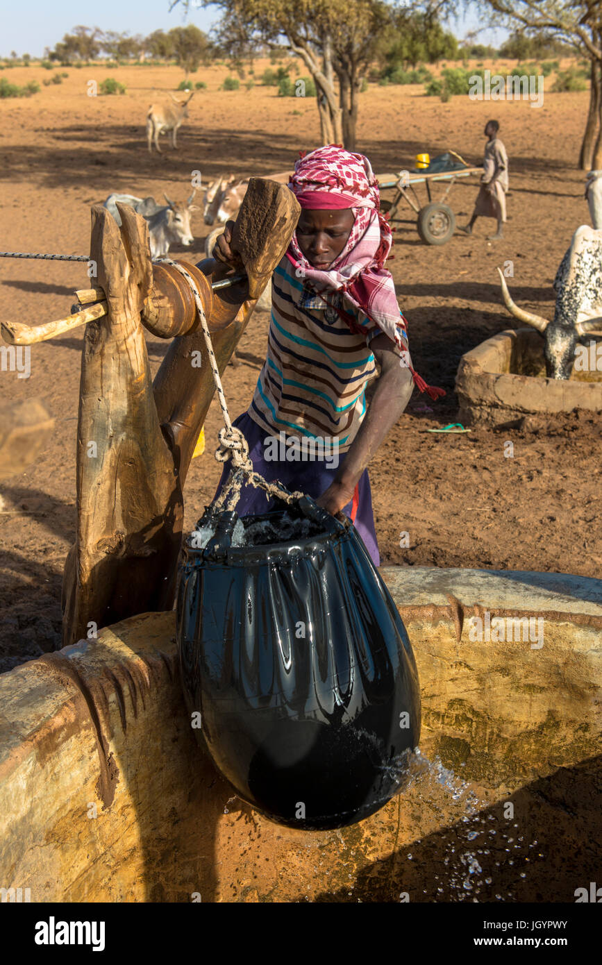 Peul boy fetching water from a well. Senegal. Stock Photo