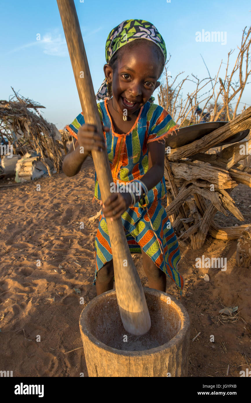 Girl using a pestle. Senegal. Stock Photo