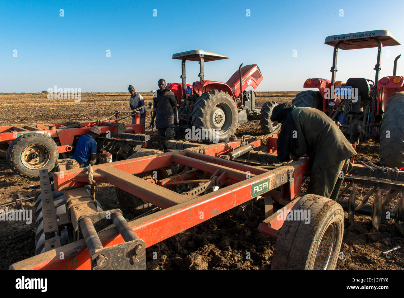 Mechanic repairing farming equipment. Senegal. Stock Photo