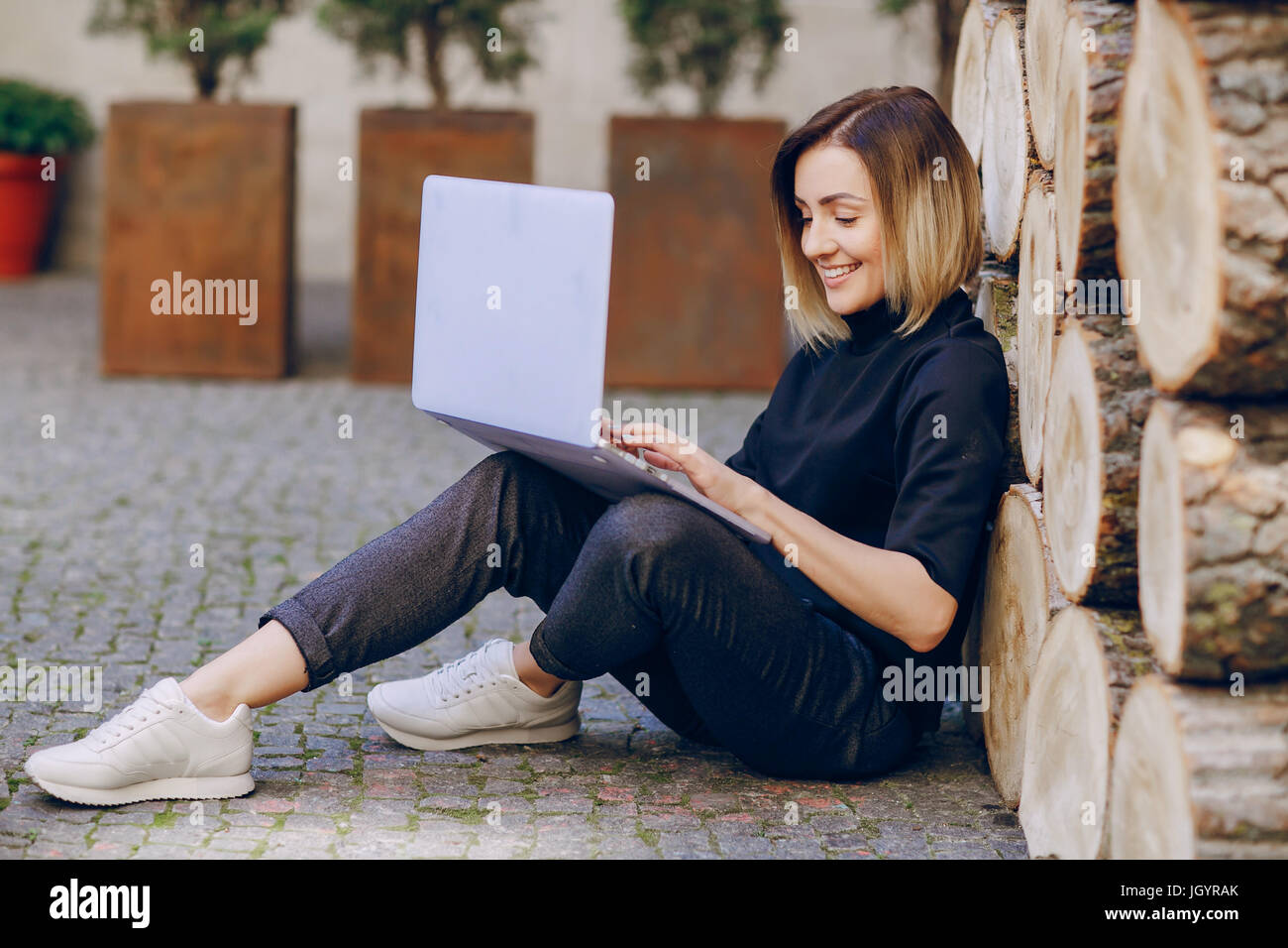 young beautiful girl using the laptop sitting smiling Stock Photo - Alamy