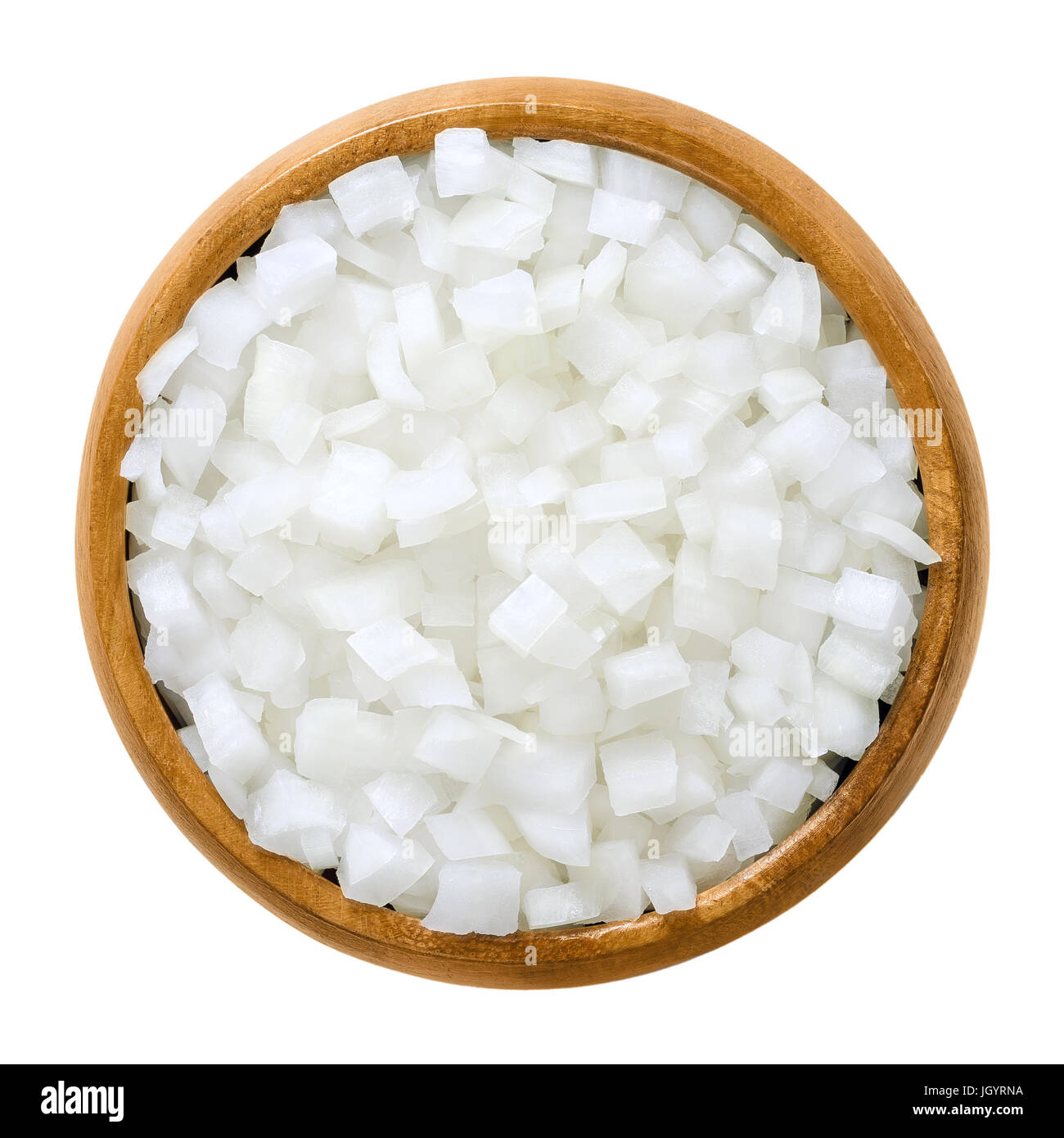 White onion cubes in wooden bowl. Chopped fresh, raw Allium cepa, also bulb or common onion. Vegetable, ingredient and staple food. Macro photo. Stock Photo