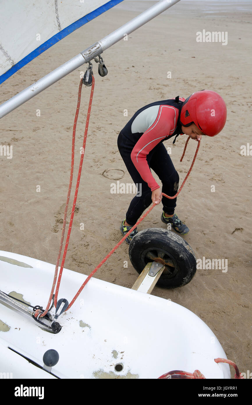 Boy rigging a sand yacht. France. Stock Photo