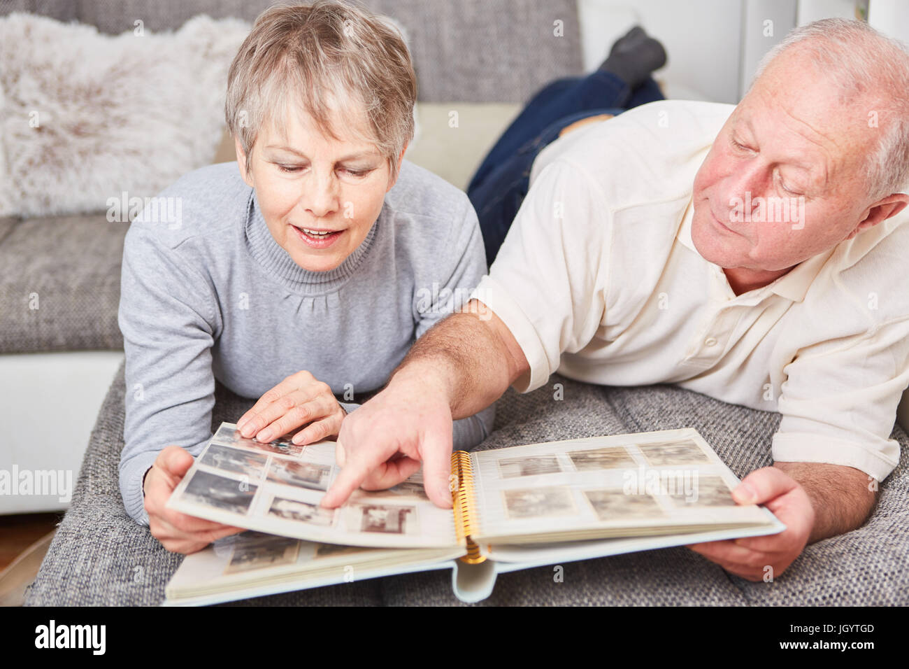 Senior couple in relaxation holding photo album Stock Photo