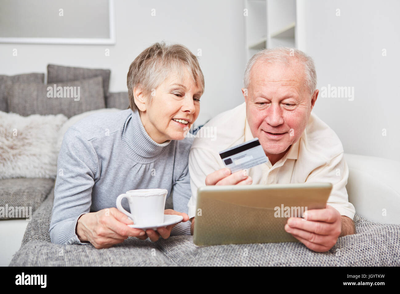 E-commerce concept with senior couple shopping online using credit card Stock Photo