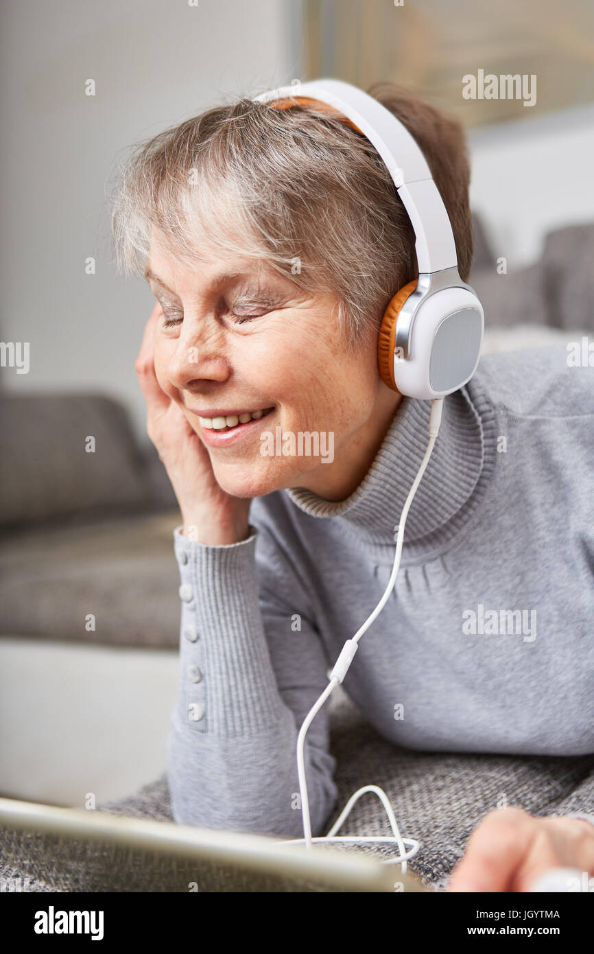 Senior woman listens to music with enjoyment for relaxation Stock Photo
