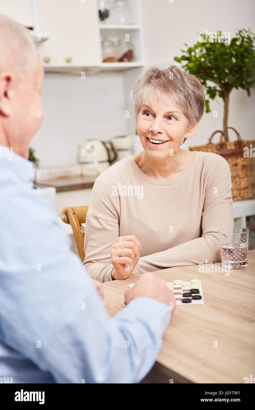 Senior couple playing board game for leisure and relaxation Stock Photo