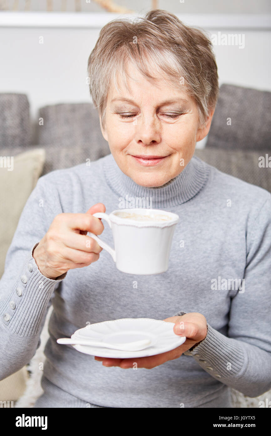 Senior woman dinking a cup of coffe  with relaxation Stock Photo