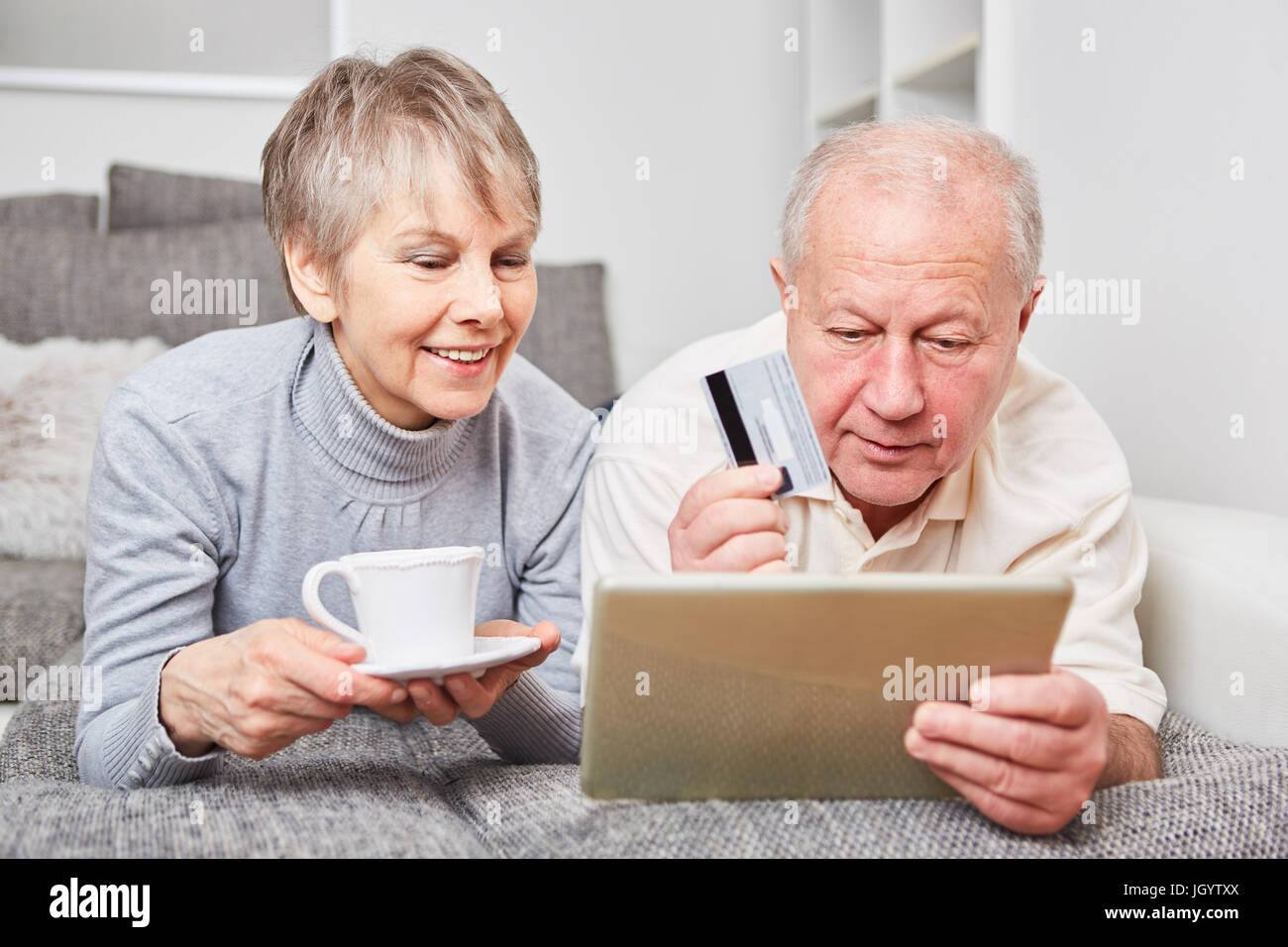 Online shopping concept with senior couple using tablet computer Stock Photo