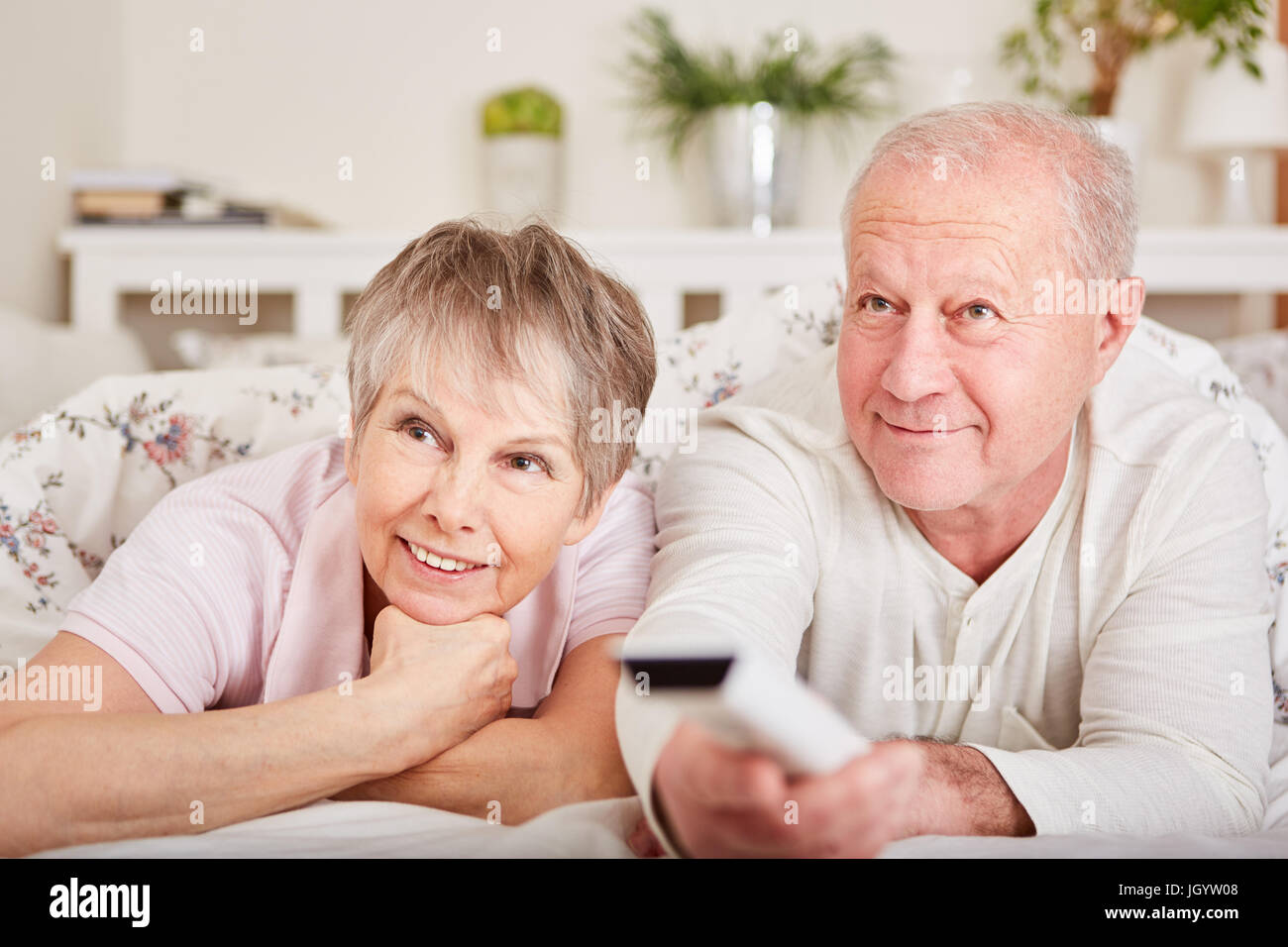 Senior couple watch TV for leisure and relaxation in their free time Stock Photo