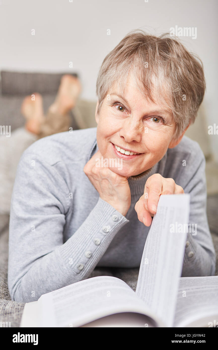 Penioner woman in retirement reads book for relaxation Stock Photo