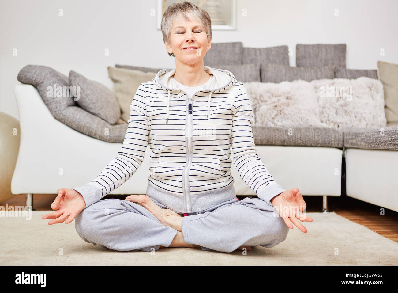 Senior woman in yoga lotus position for meditation and relaxation Stock Photo