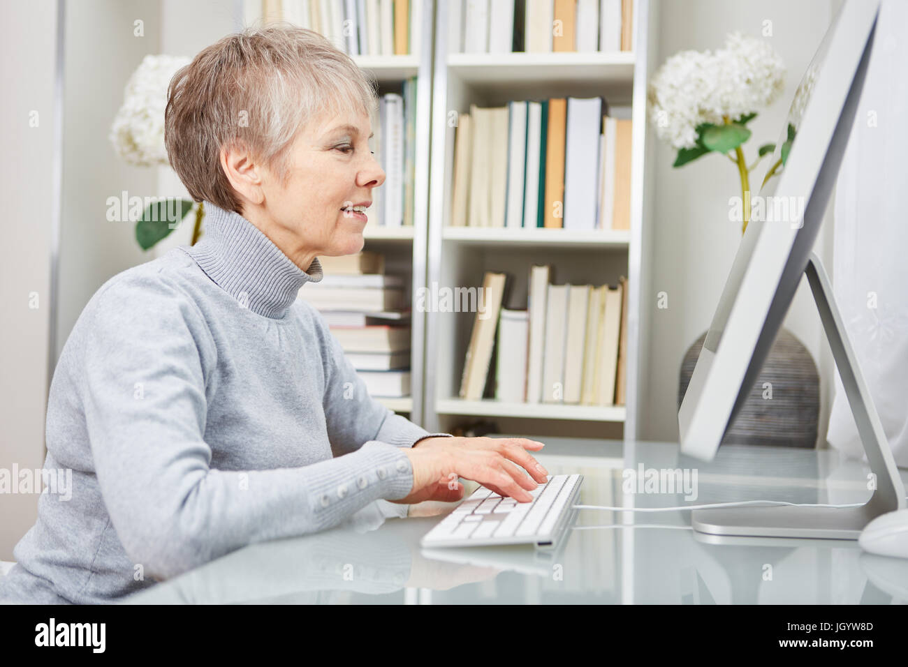 Senior businesswoman working with computer at her place of work Stock Photo