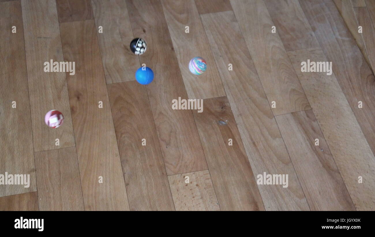 4k video rubber balls-jumpers jump on linoleum Stock Photo