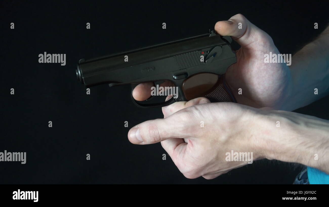 young man holding a black gun Stock Photo - Alamy