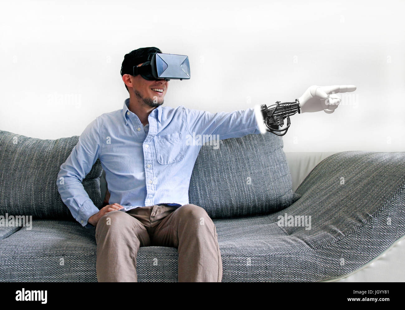 Man in shirt with VR glasses points with virtual finger Stock Photo