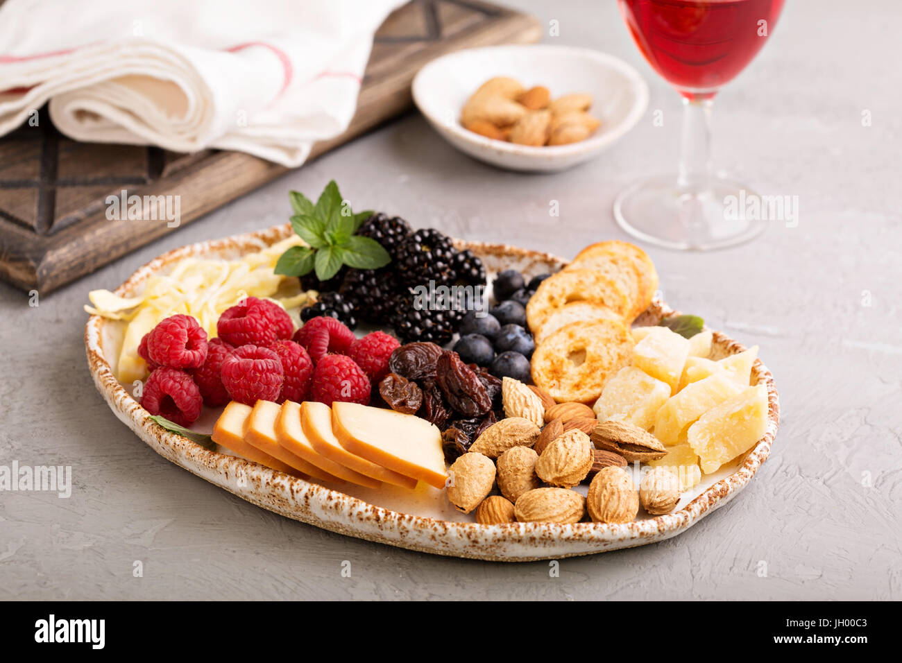 Cheese plate with nuts and berries Stock Photo