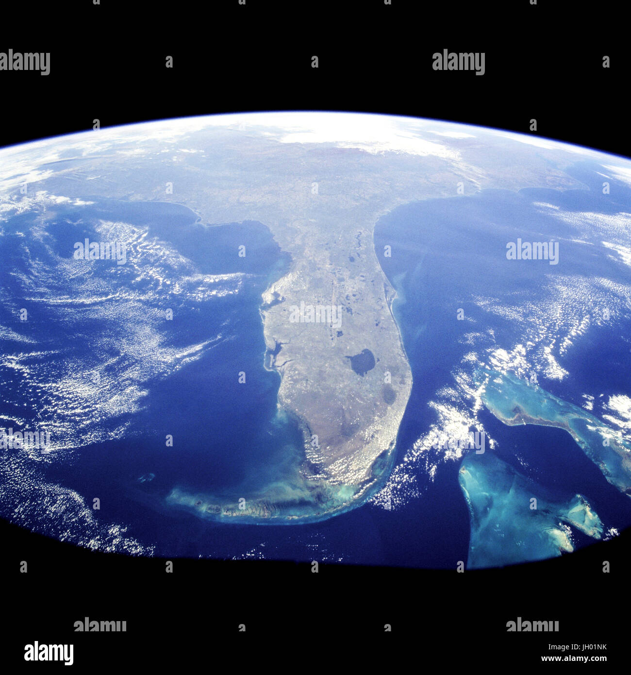 Taken during the STS-95 mission from a point over Cuba, this photo shows an  oblique, foreshortened view of the Florida Peninsula, with the light blue,  shallow seafloor of both the Florida Keys (