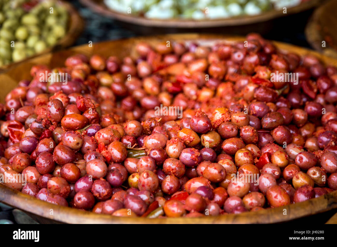 Red olives on a large wooden plate at Marché de Wazemmes (Wazemmes Market), Lille, France Stock Photo
