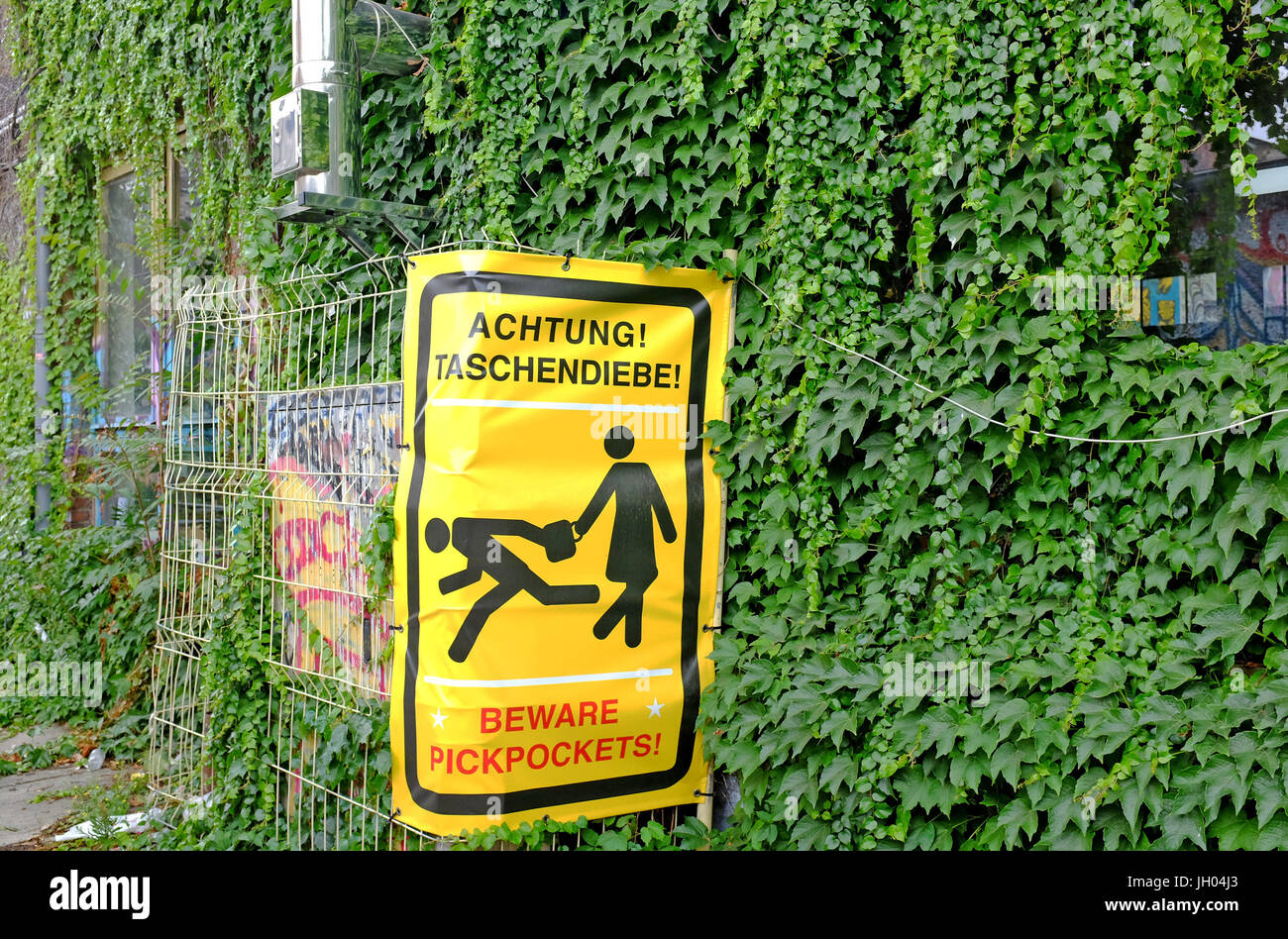 Sign warning visitors in the artistic neighborhood of Friedrichshain of the presence of pickpocketing. Stock Photo