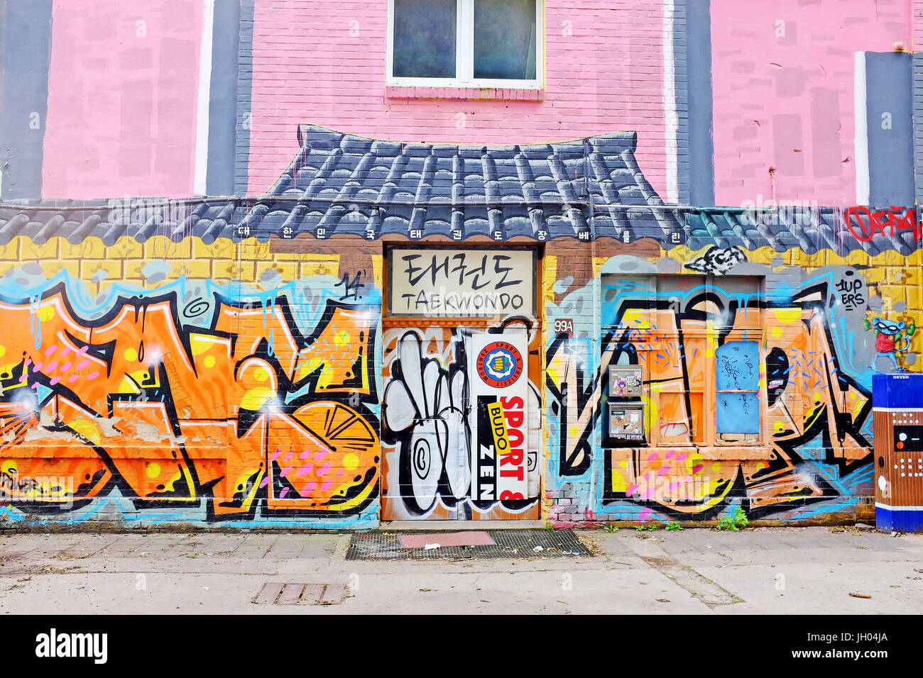 Grafitti filled building designed to resemble an Asian building offering Taekwondo in Berlin, Germany. Stock Photo