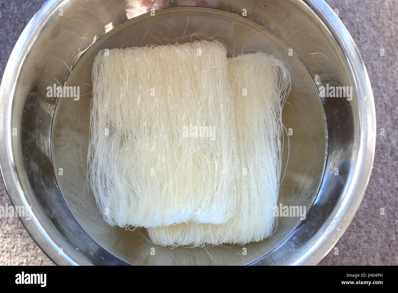 Soaking Rice vermicelli noodles before cooking Stock Photo