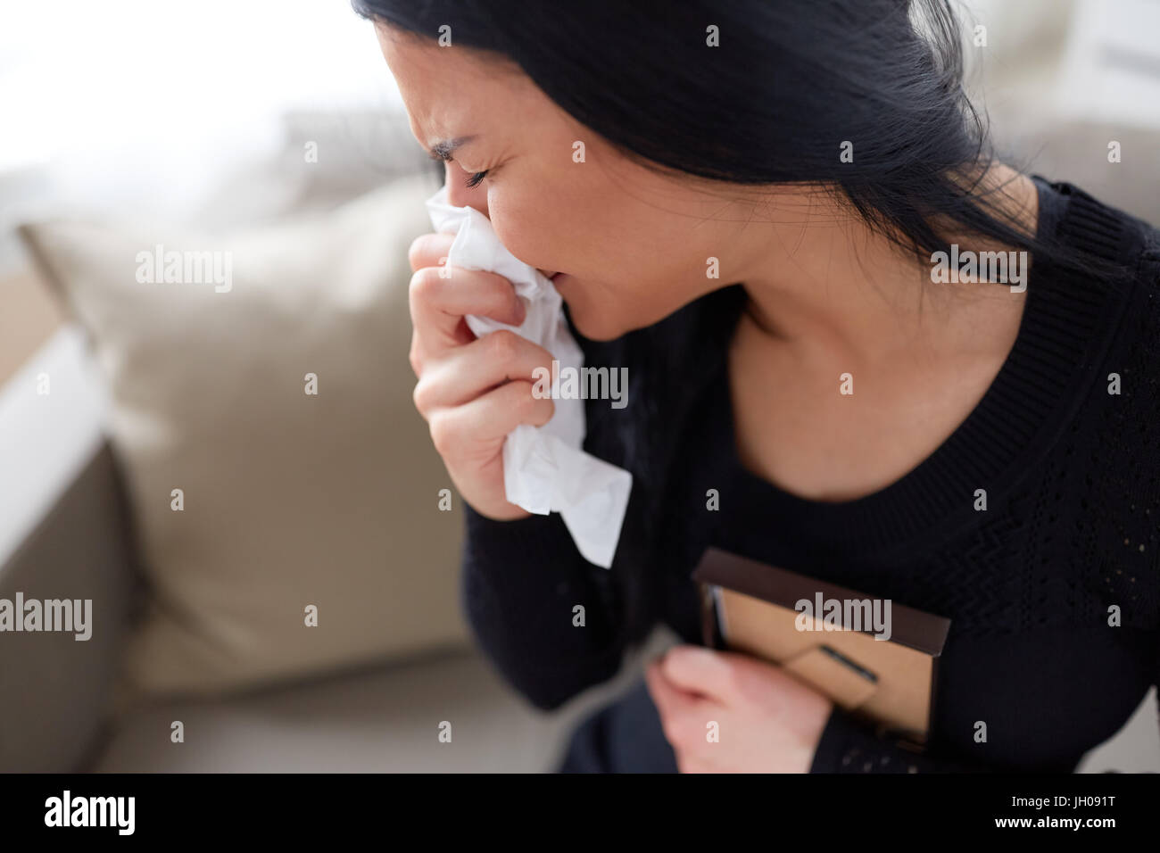 crying woman with photo frame at funeral day Stock Photo