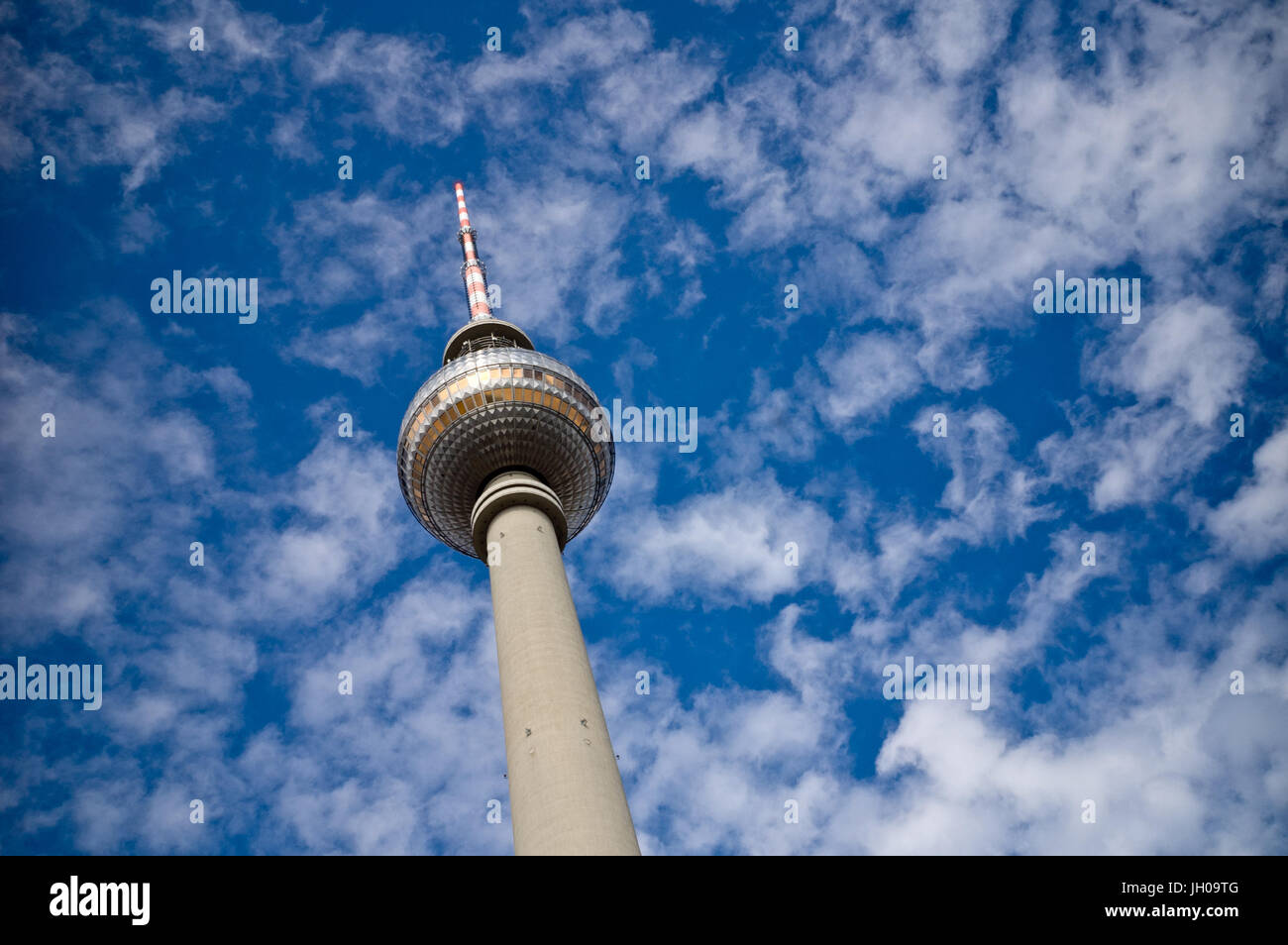 The TV tower on the Alexanderplatz in Berlin with blue sky and white clouds in the background. Stock Photo