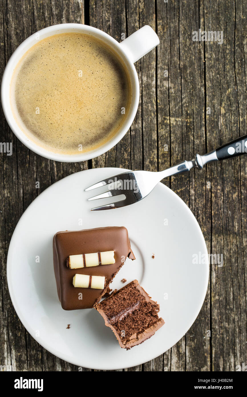 Sweet chocolate dessert on dessert plate and coffee cup. Top view. Stock Photo