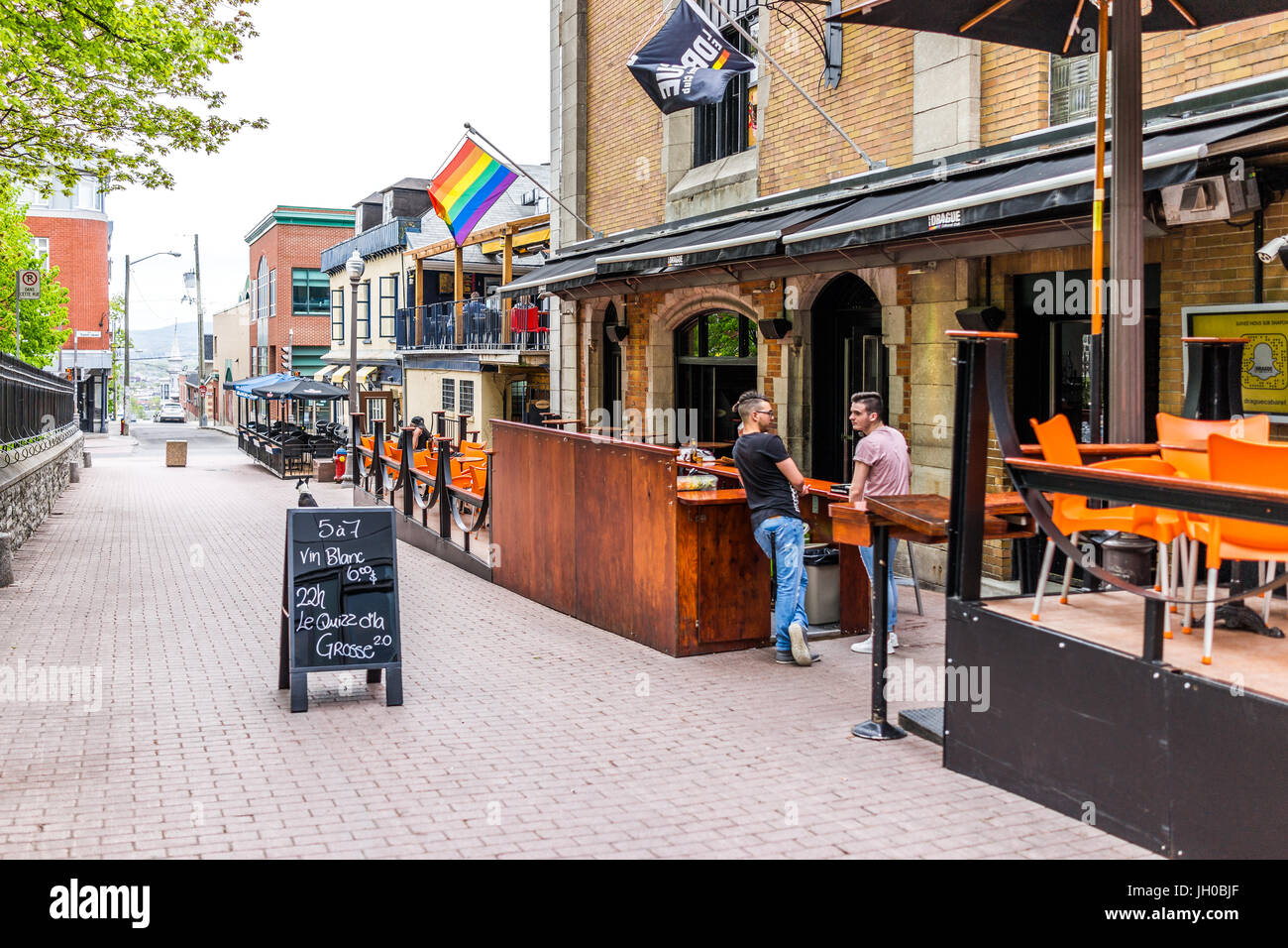 Quebec City, Canada - May 29, 2017: Saint Jean Baptiste area with gay friendly restaurant on Augustin street with menu sign and sidewalk Stock Photo