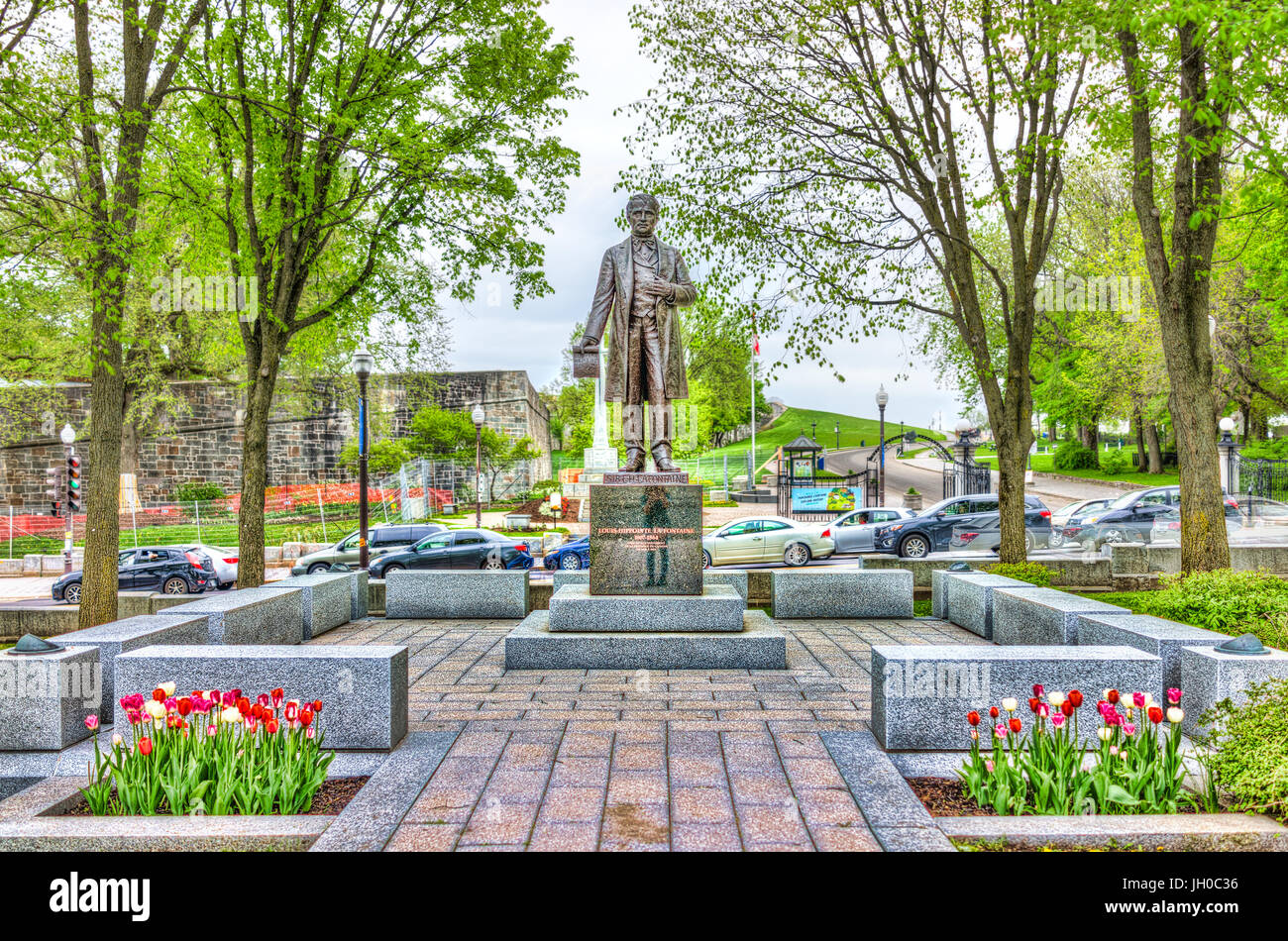 Quebec City, Canada - May 29, 2017: Statue of Sir Lafontaine in summer with tulips flowers by Parliament park Stock Photo