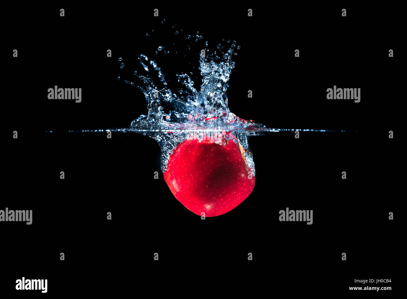 Red apple and water splash isolated on black background Stock Photo