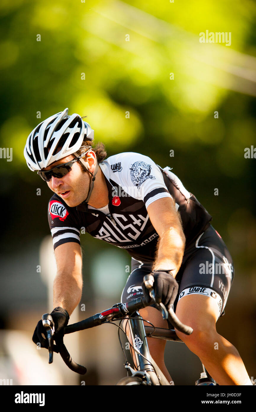 An athletic young male cyclist competes in an urban road race Stock ...