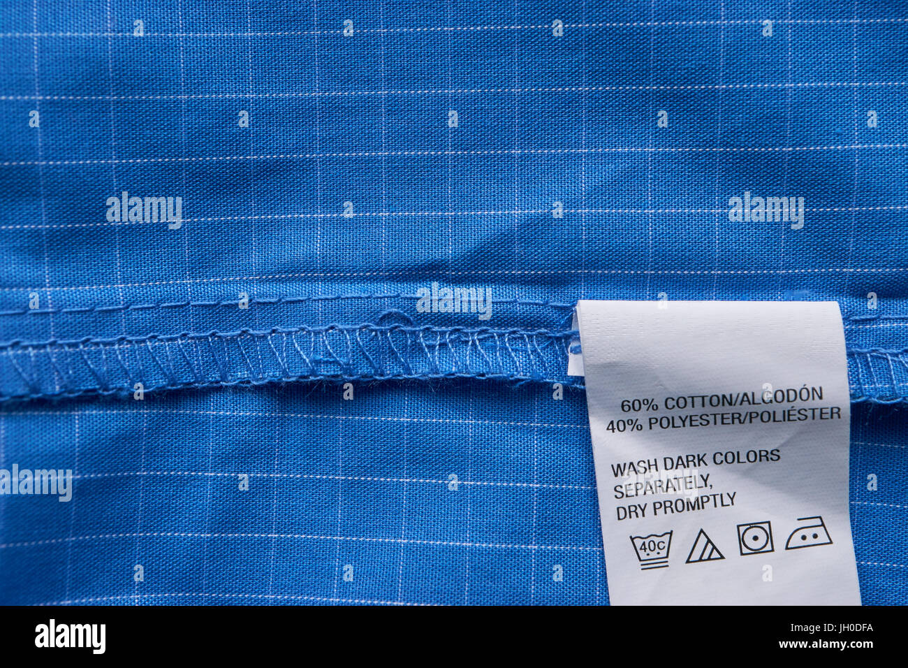 closeup clothes label blue plaid shirt made from cotton and polyester Stock Photo