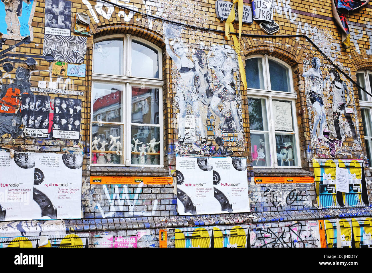 Graffiti covered exterior of old factory building in the Friedrichshain-Kreuzberg area of Berlin, Germany, a popular alternative tourism attraction. Stock Photo