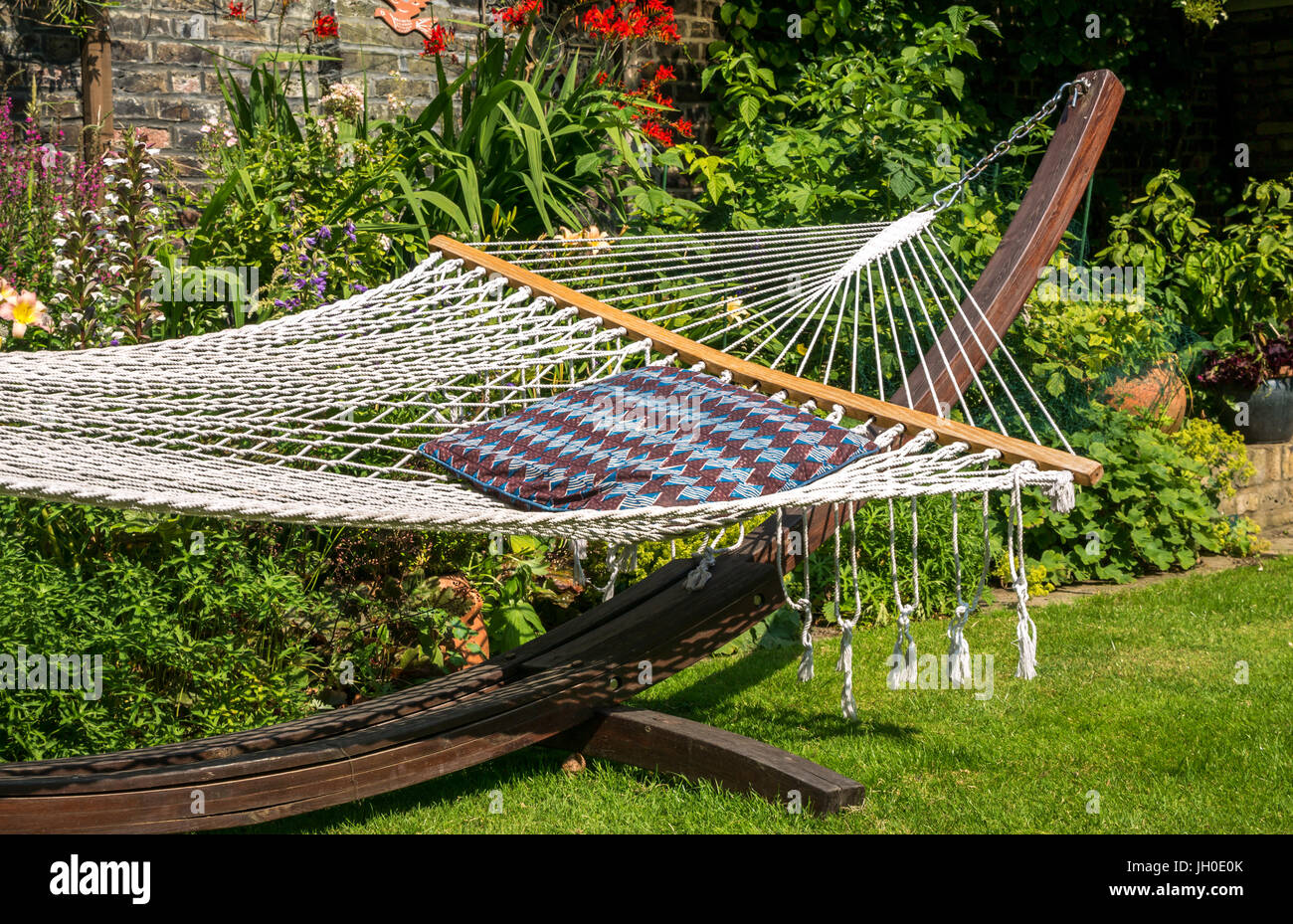 A net hammock on a wooden frame, London garden in summer sunshine, England,  UK Stock Photo - Alamy