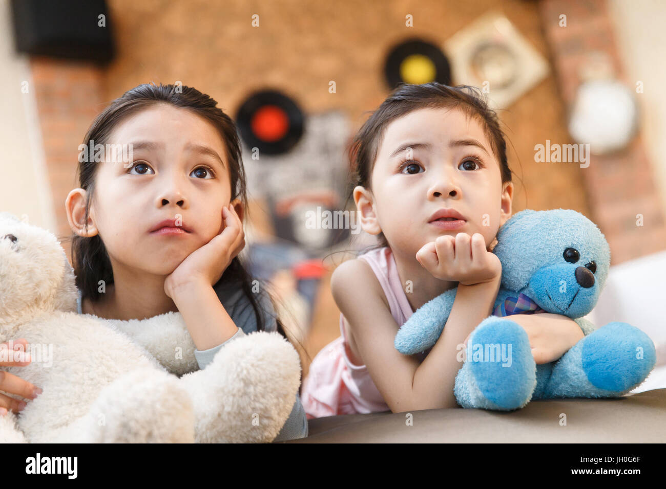 Two girls watching TV at home Stock Photo