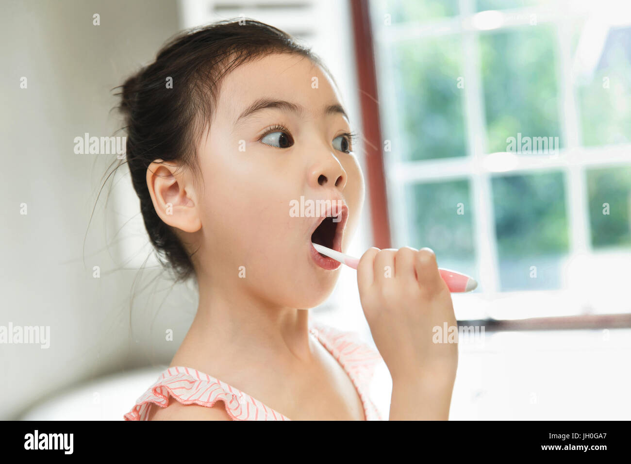 Little girl brushing teeth Stock Photo