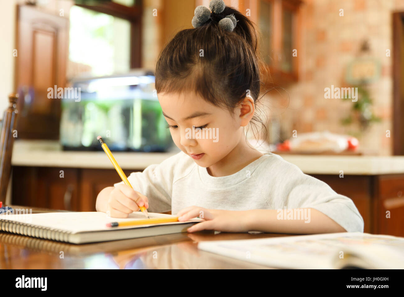 Little girl studying at home Stock Photo - Alamy