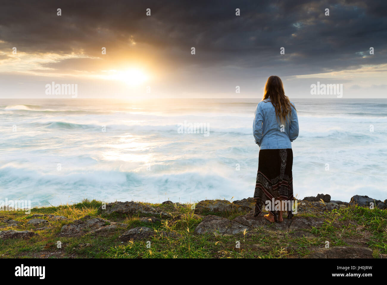 Woman watching sunset over ocean hi-res stock photography and images ...