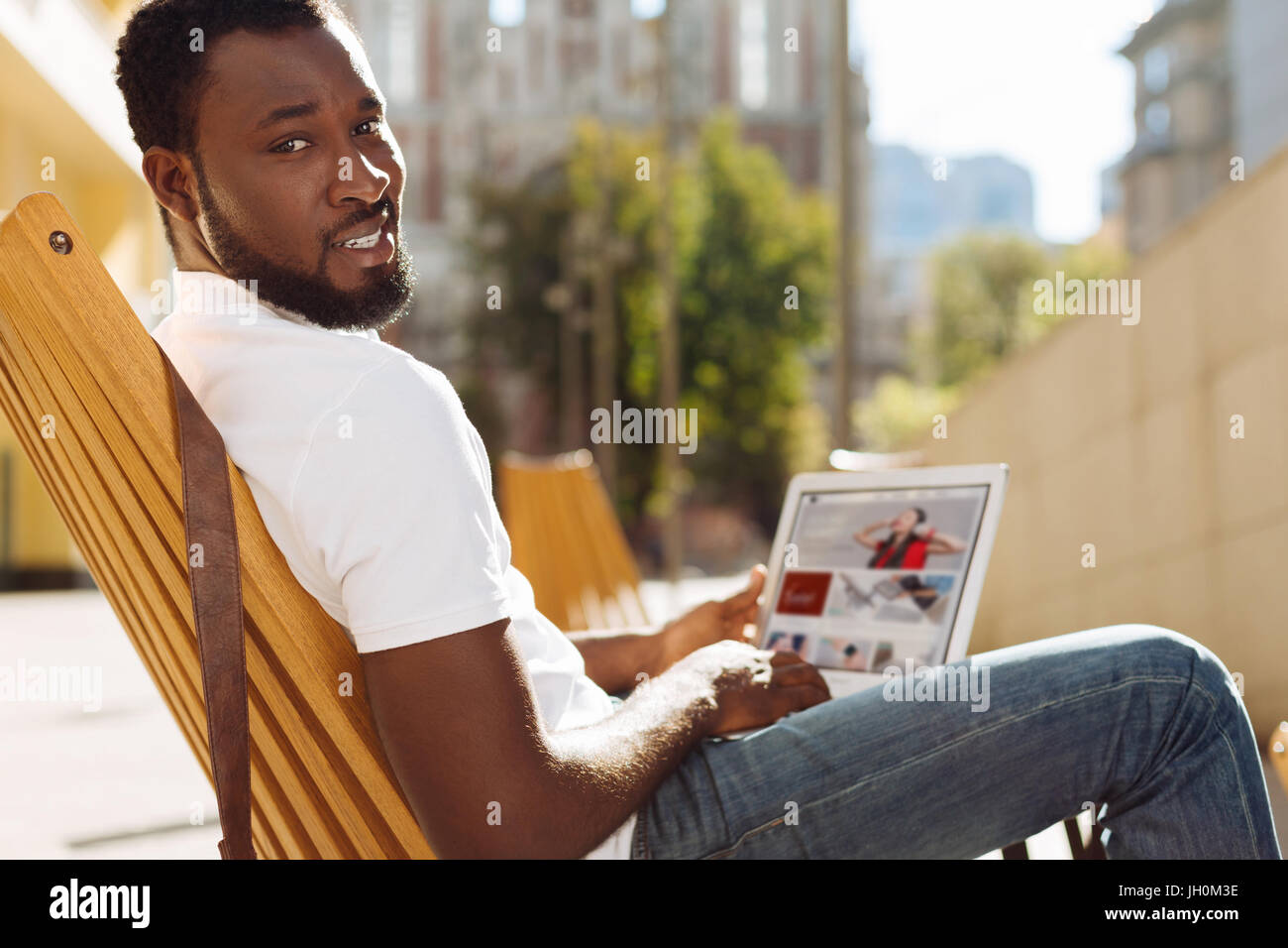 Smart energetic man sitting on a terrace Stock Photo