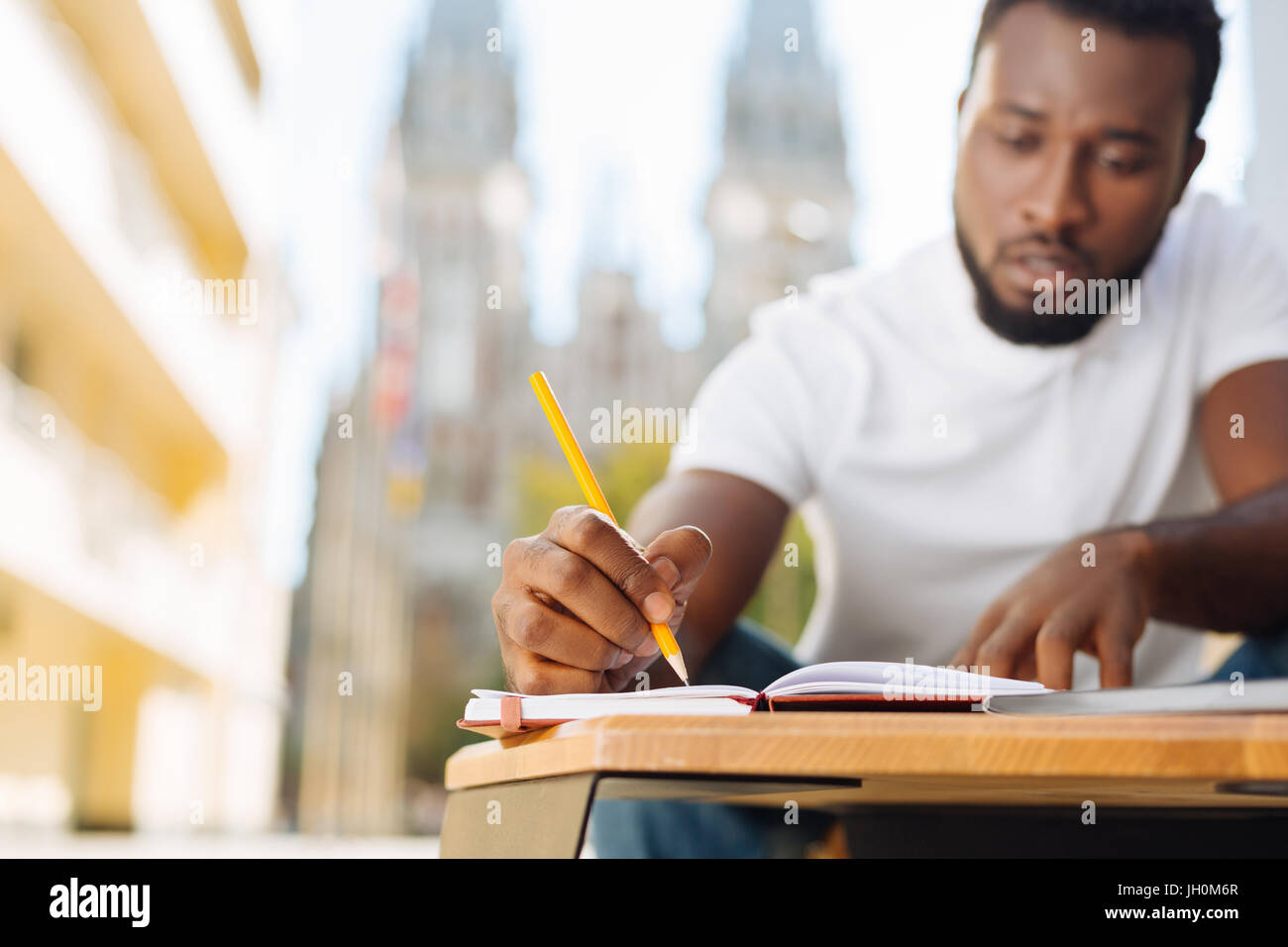 Charming intelligent man writing a plan Stock Photo