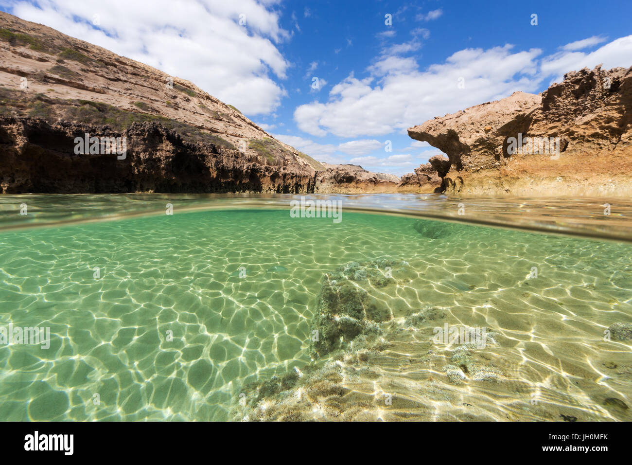 A split shot of a pristine rock pool on an isolated coastline in South Australia. Stock Photo