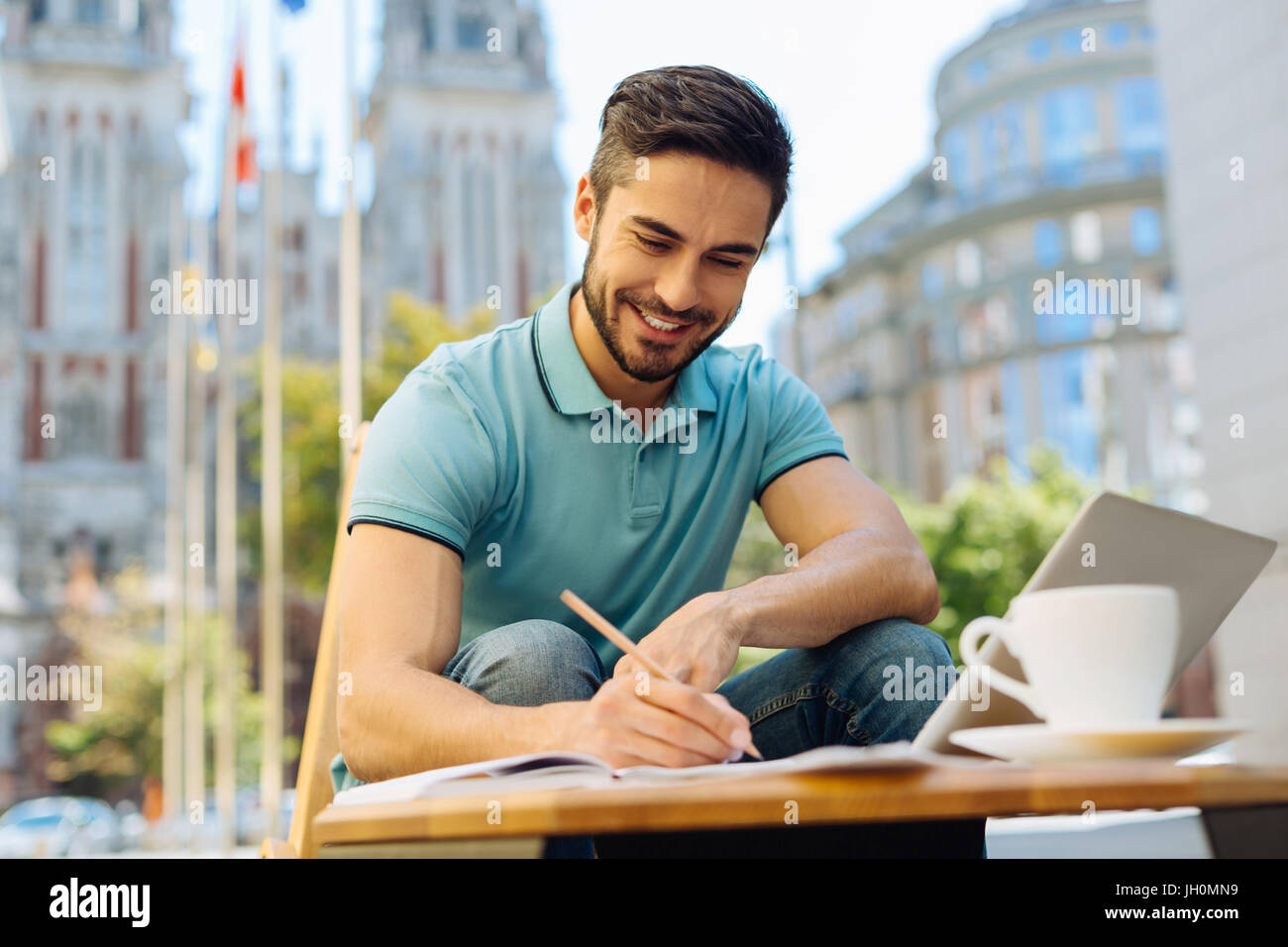 Pleasant excited man working on something interesting Stock Photo