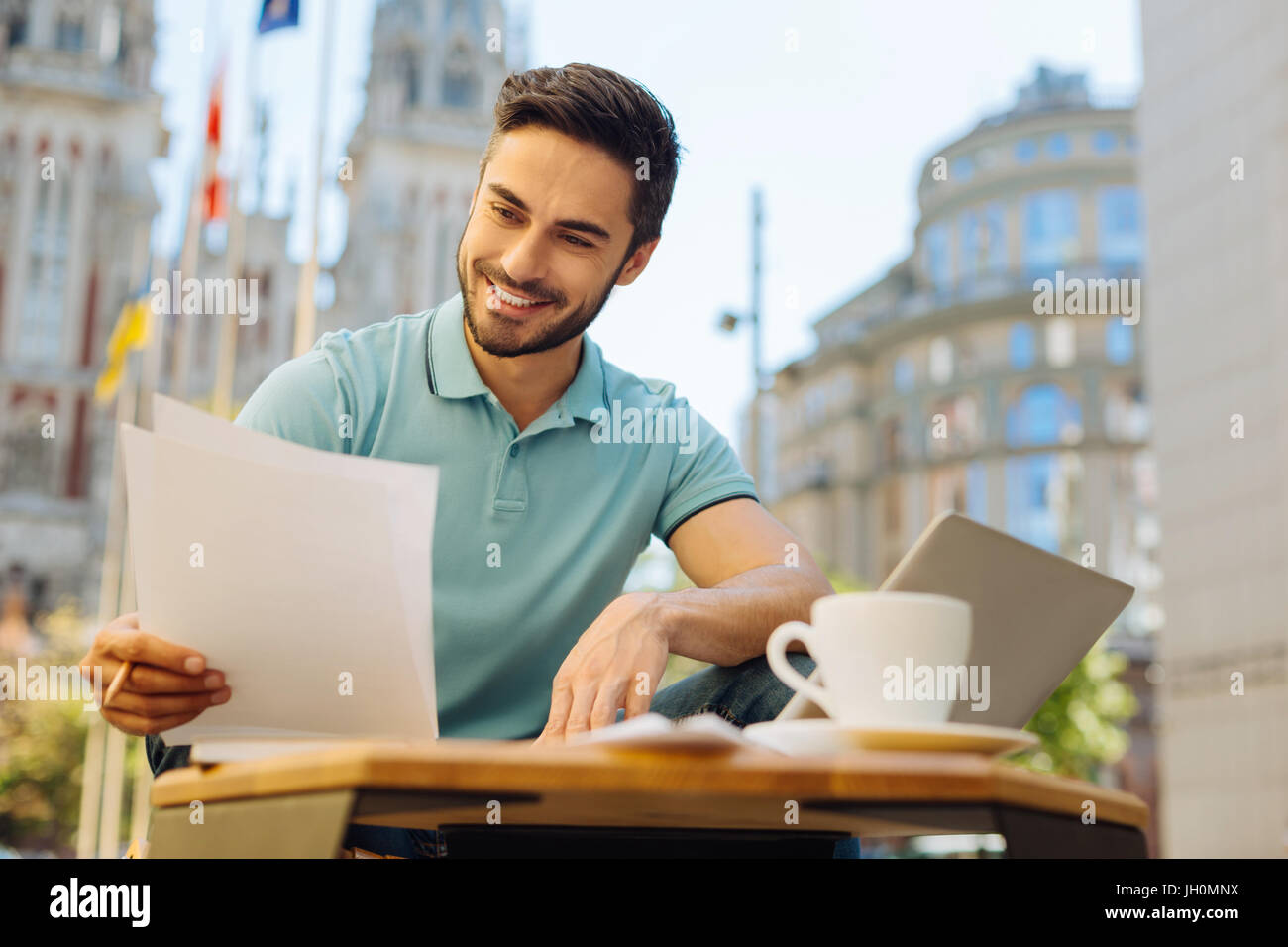 Committed handsome man reading the documents carefully Stock Photo