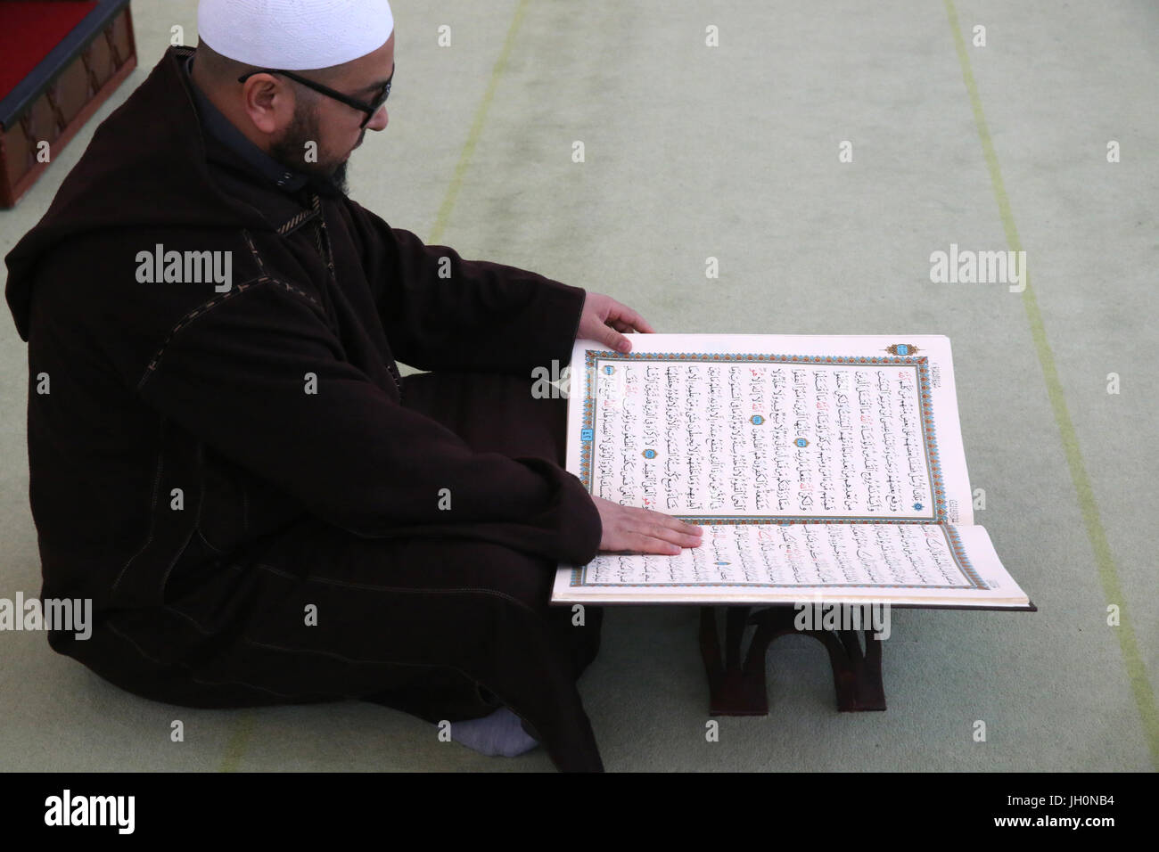 Imam reading the Quran in a mosque.  France. Stock Photo