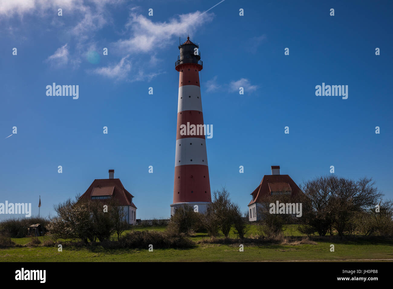 Lighthouse with Lighthouse keeper houses in German North Sea Region Westerhevesand next to Sankt Peter Ording Stock Photo